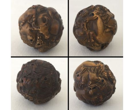 A signed carved wood spherical shaped netsuke. Depicting the 12 animals of the Chinese zodiac. Approx. 4cm diameter.