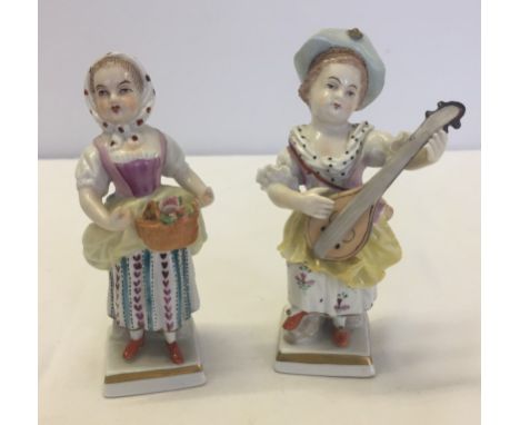 2 Sampson porcelain figures. Both young females, one playing a mandolin & the other carrying a basket of flowers - damage to 