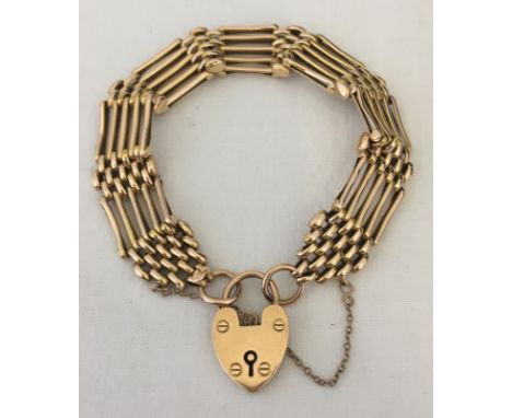 A vintage 15ct gold five bar gate bracelet with heart padlock. Flexible joints have decorative fronts. Approx. 16g. 