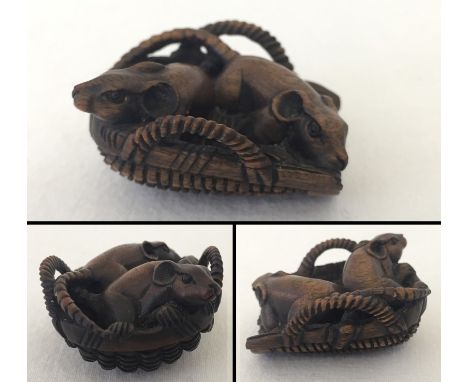 A signed carved wooden netsuke of 2 rats in a basket.  Approx. 4.5 x 4cm.