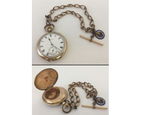 A vintage Elgin gold plated pocket watch in working order. On gold tone chain with gold plated T bar and enamelled Victorian 