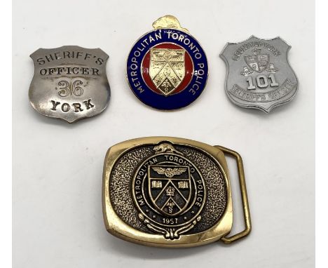 A vintage York Sheriffs Officer badge along with one other and a Toronto Police  badge and a commemorative buckle