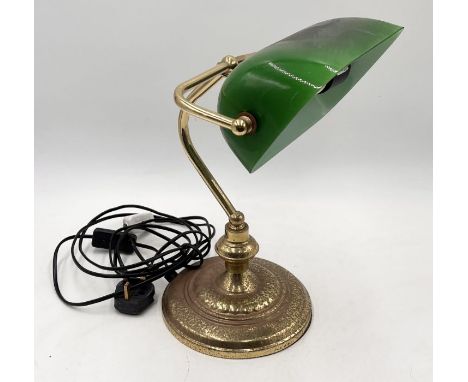 A banker's lamp with green glass shade