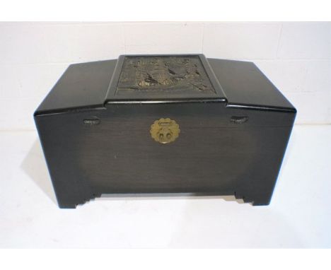A camphorwood trunk with carved panel on top depicting oriental sailing boat, length 100cm, depth 56cm, height 57cm.
