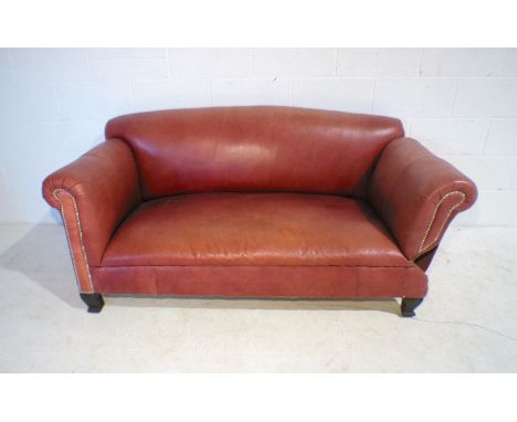 A modern red leather drop-arm sofa with brass stud detailing, length 173cm.