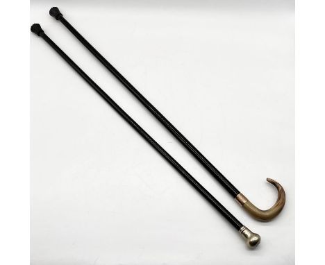 An Edwardian ebony walking stick with polished horn handle and 9ct gold ferrule along with another ebony cane with SCM top an