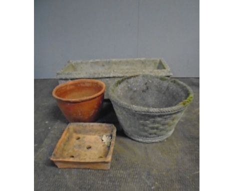 A weathered reconstituted stone planter plus a similar round planter and two pots.