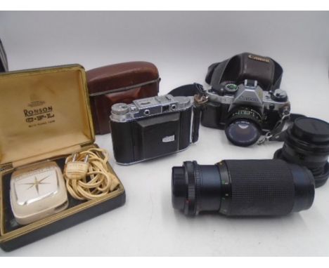 A Canon AE-1 camera along with a Solida III, two lenses etc.