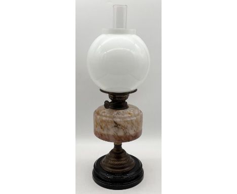 A turn of the century oil lamp with globular shade and marble effect glass well - height 42cm