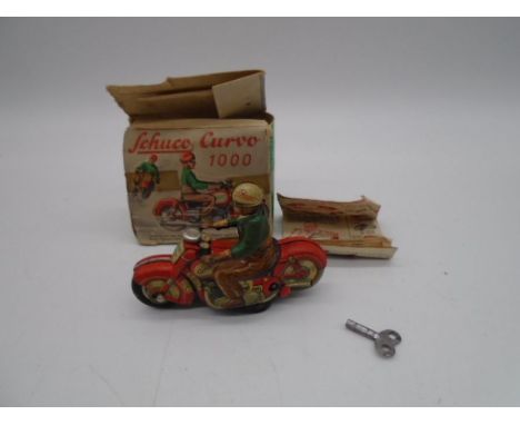 A boxed Schuco Curvo 1000 tinplate clockwork motorcycle with key and instructions - box A/F
