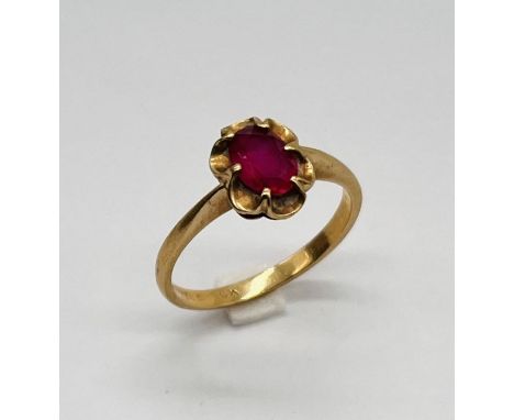 A 10ct gold ring set with a synthetic ruby