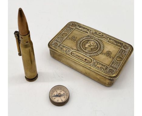 A Queen Mary tin, trench art lighter and small German marked compass