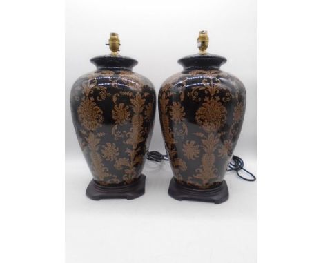 A pair of large decorative lamps, includes a pair of unused lamp shades. Approx height of lamp (minus shade) 47cm