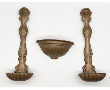A pair of gold painted cast iron wall hanging ladle spoons along with part of a similar wall sconce