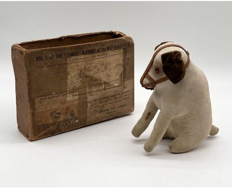 An early 20th century velvet seated dog, likely Steiff but with no button to ear, glass eyes and leather muzzle with some sma