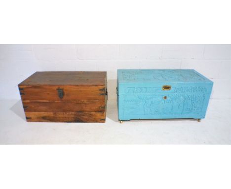 A painted camphorwood chest with carved Oriental decoration along with a wooden trunk.