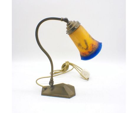An Art Nouveau style brass lamp with decorative glass shade.