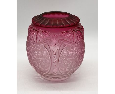 A Victorian cranberry oil lamp shade with raised detail and etched design height 20cm