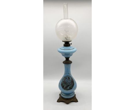 An blue opaline oil lamp with frosted shade and printed scene of two seated children to base - overall height including chimn