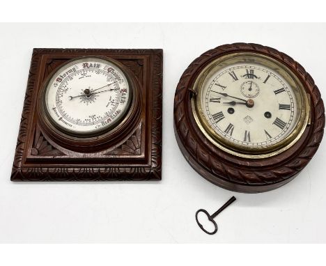 A vintage enamel dial barometer along with a wooden rope edged clock 