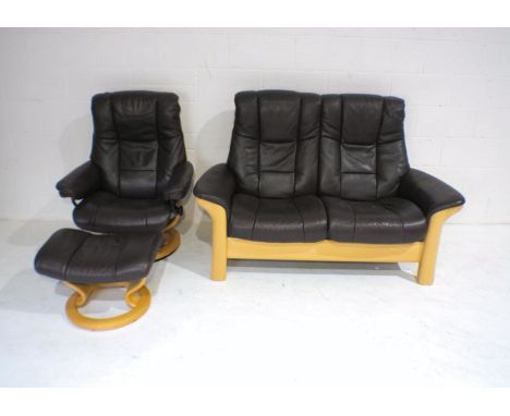 A brown 'Stressless' two-seater reclining sofa with armchair and footstool.