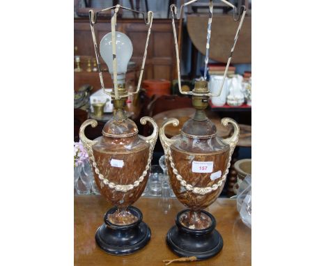A PAIR OF NEO-CLASSICAL DESIGN MARBLED CERAMIC URNS mounted as lamps (examine)