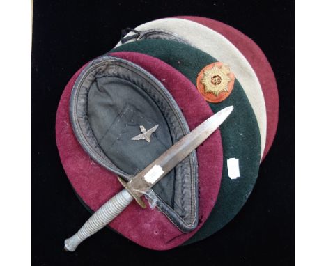 A COMMANDO DAGGER, a hat badge and a collection of Vintage military berets