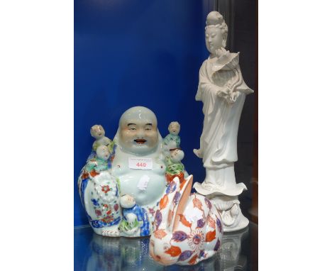 A CHINESE REPUBLIC PERIOD LAUGHING BUDDHA, painted in polychrome, 20cm high, a Blanc De Chine ceramic figure modelled as Guan