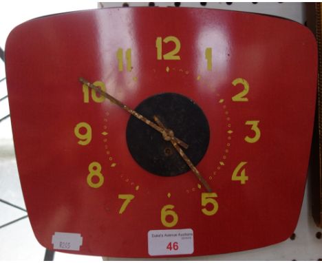 A VINTAGE 1960'S RED FORMICA WALL CLOCK with yellow numerals