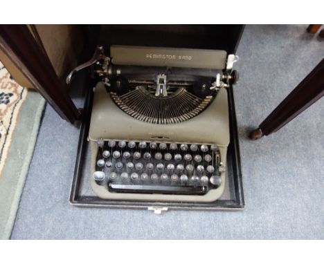 A VINTAGE REMINGTON RAND PORTABLE TYPEWRITER and another similar and a watercolour