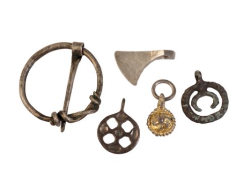 A VIKING WHITE METAL MINIATURE AXE HEAD PENDANT, a Saxon white metal cloak pin, a small silver gilt Saxon pendant of spiral r