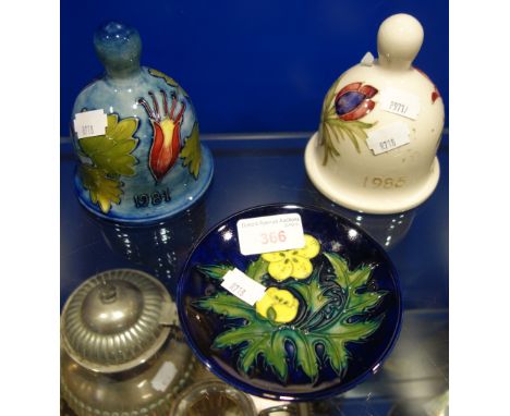 MOORCROFT: TWO CERAMIC BELLS, 11.5cm high approx, and a small pin dish (3)
