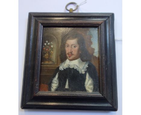 A MINIATURE OIL PORTRAIT OF A JAMES I GENTLEMAN, with a heraldic crest verso, 7.5cm high (within frame)