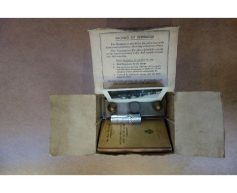 WORLD WAR II INTEREST; a gas mask box containing Air Raid precautions book, a lighter, a brass heater and VE parade photo 194