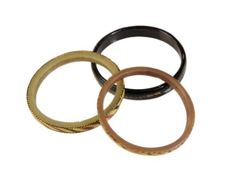 A ROMAN GLASS BANGLE, the black glass ring with decorative cream coloured dotted band, and two others of similar design to ea