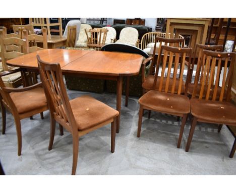 A vintage teak extending dining table and six (four plus two) rail back dining chairsm labelled G Plan, little bit of water d