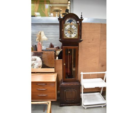 A reproduction long case clock having glazed panel to front
