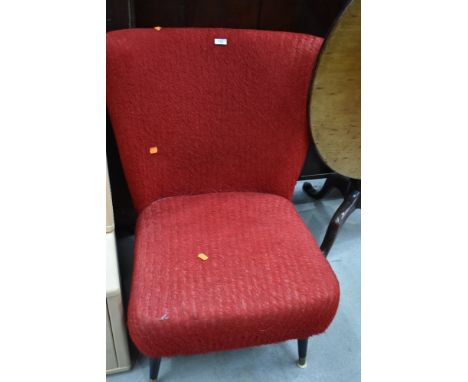 A vintage nursing chair on dansette style legs
