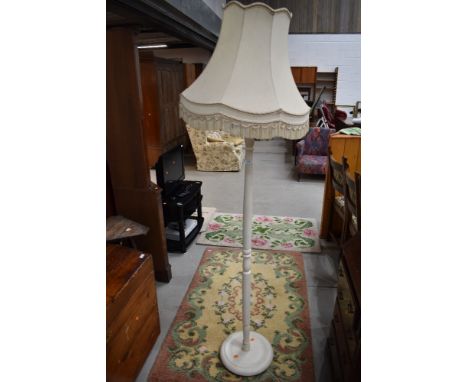A traditional painted standard lamp and shade