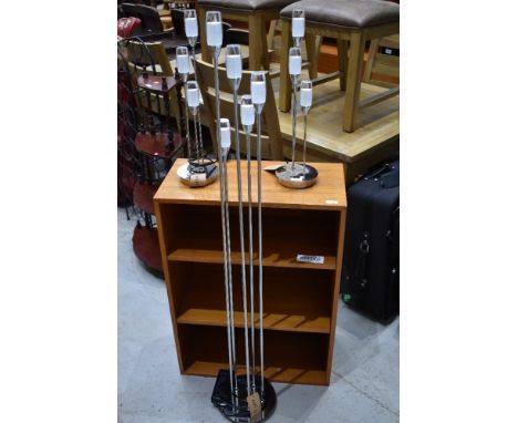 A floor mounted tear drop design lamp and two matching smaller versions