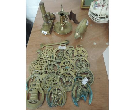 A selection of brassware including horse brasses and chamber stick