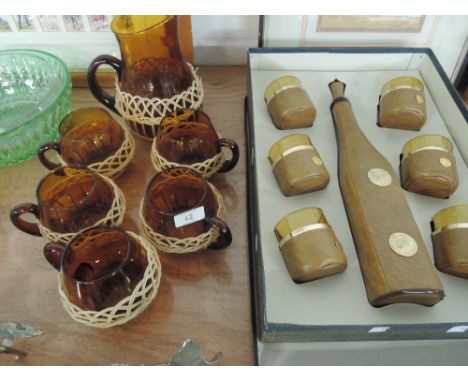 A set of retro smoked glass cups and jug and a boxed leather clad decanter and water glasses