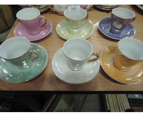 A harlequin set of six coffee cups and saucers