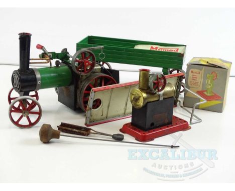 A MAMOD live steam traction engine together with 4 wheel trailer, a stationery steam engine and a model power press accessory