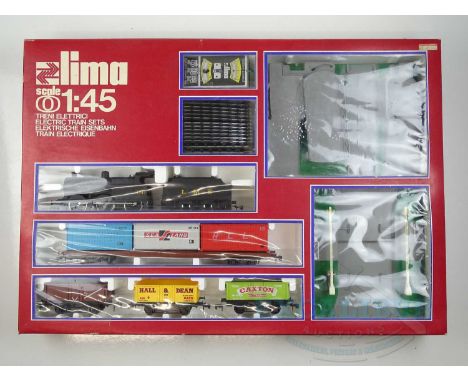 A LIMA O gauge British Outline freight train set comprising a Class 4F steam loco in LMS black livery together with four asso