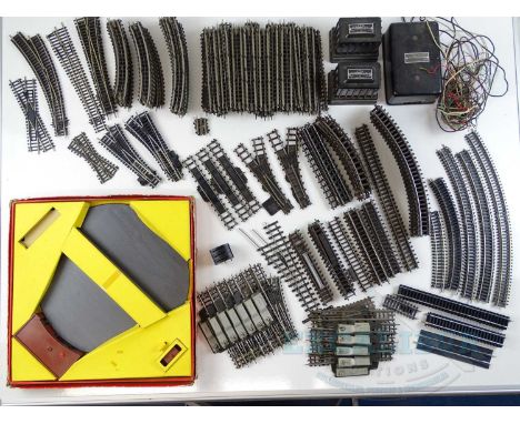 A large group of mostly unboxed TRI-ANG OO gauge track and controllers to include a boxed manual turntable - G, turntable in 