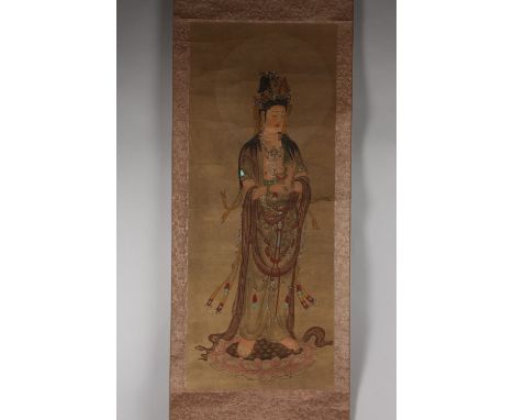 A CHINESE SCROLL PAINTING ON PAPER, depicting Guanyin stood upon a lotus.