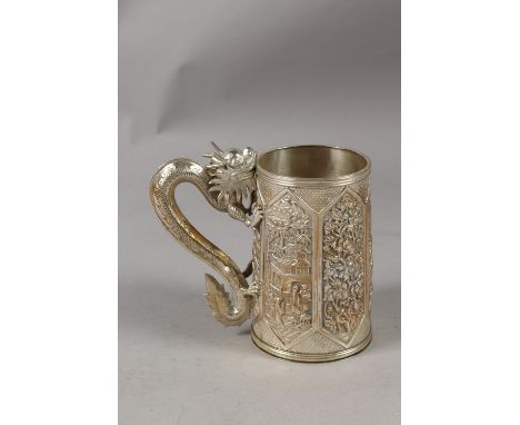 A VERY FINE CHINESE SILVER TANKARD, with cast dragon form handle, finely engraved with relief panels of figures and flora, we