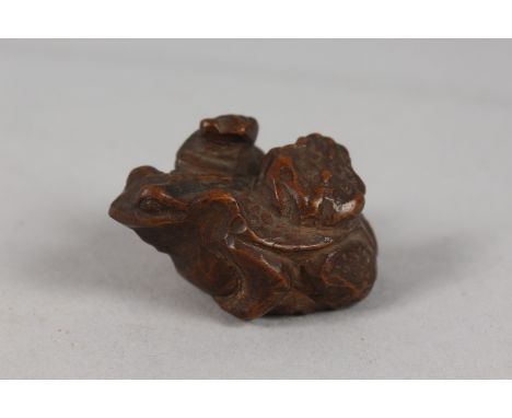 A JAPANESE CARVED WOOD 'THREE-TOAD' NETSUKE, 4.5cm.