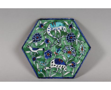 AN EARLY 20TH CENTURY PALISTIAN ARMENIAN HEXAGOAL POTTERY TILE, depicting birds and folate motifs, 17cm at widest point.